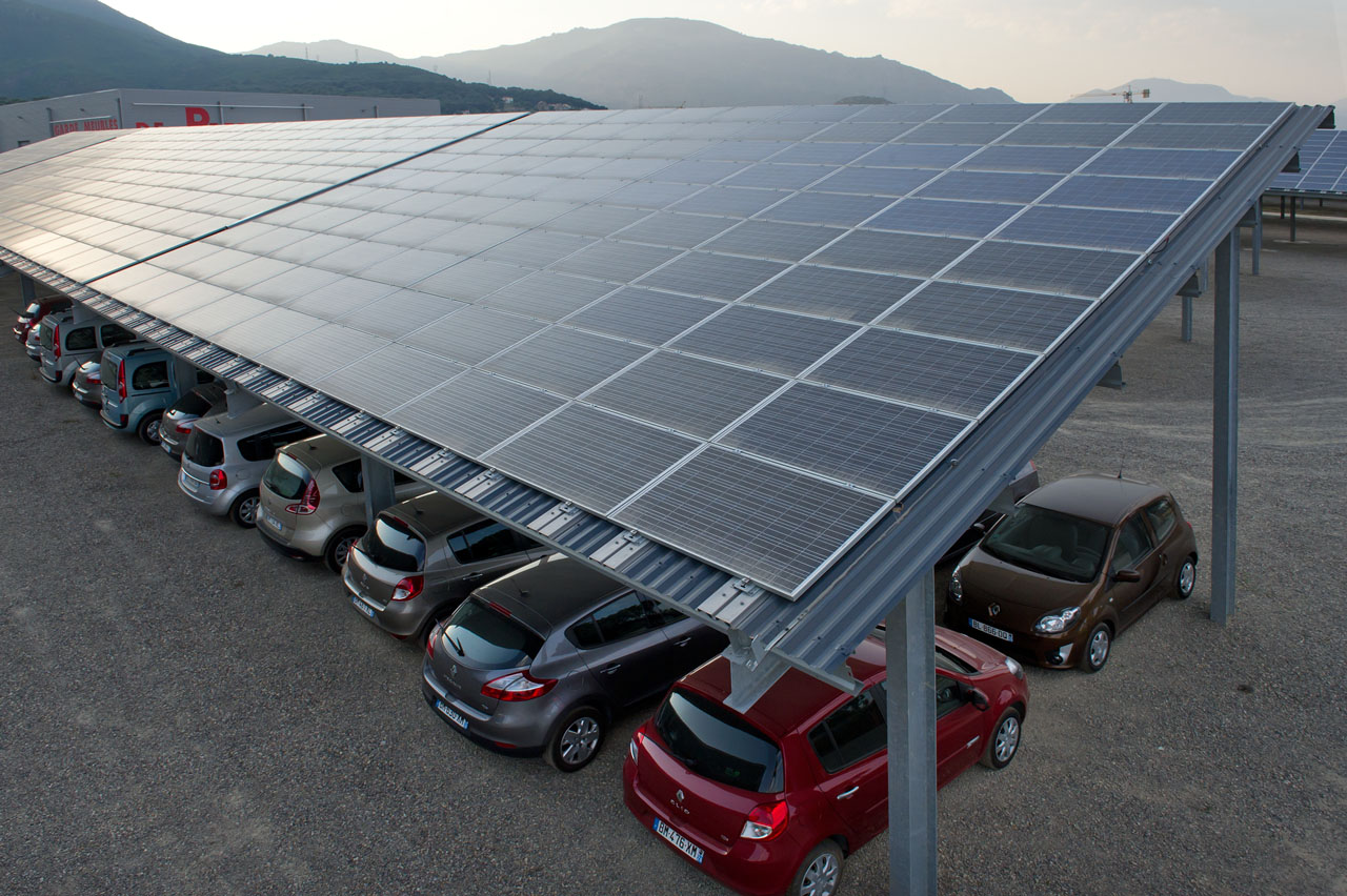 solar panels, with cars underneath